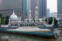 Sultan Abdul Samad Jamek Mosque and Kolam Biru viewed from bridge over Klang River in Kuala Lumpur