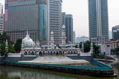 Sultan Abdul Samad Jamek Mosque and Kolam Biru in Kuala Lumpur viewed from the bridge along Klang River