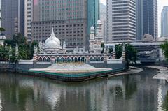 Sultan Abdul Samad Jamek Mosque and Kolam Biru viewed from bridge over Klang River in Kuala Lumpur