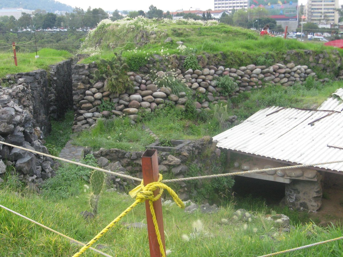 Depression with remnants of five altars on Cuicuilco main circular pyramid under protective corrugated metal roof