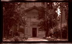 Trees and vegetation-lined path leading to the front entrance of the Church of Saint Paul at the Three Fountains in Rome