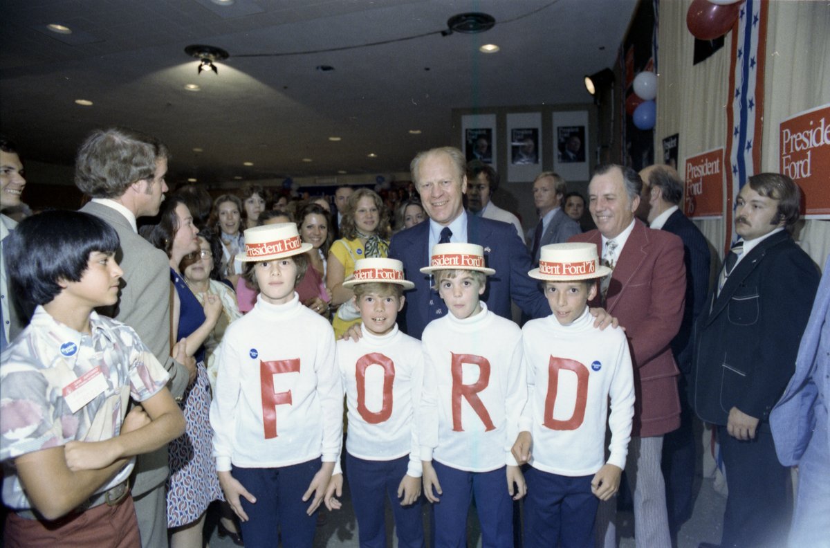 President Gerald R. Ford standing with children wearing F-O-R-D shirts at a reception in San Antonio, Texas