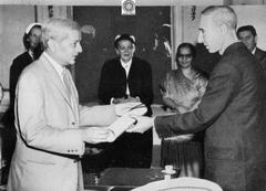 Dr. J. R. Oppenheimer receiving honorary degree diploma from Indian Ambassador G.L. Mehta at Indian Embassy Washington 1957