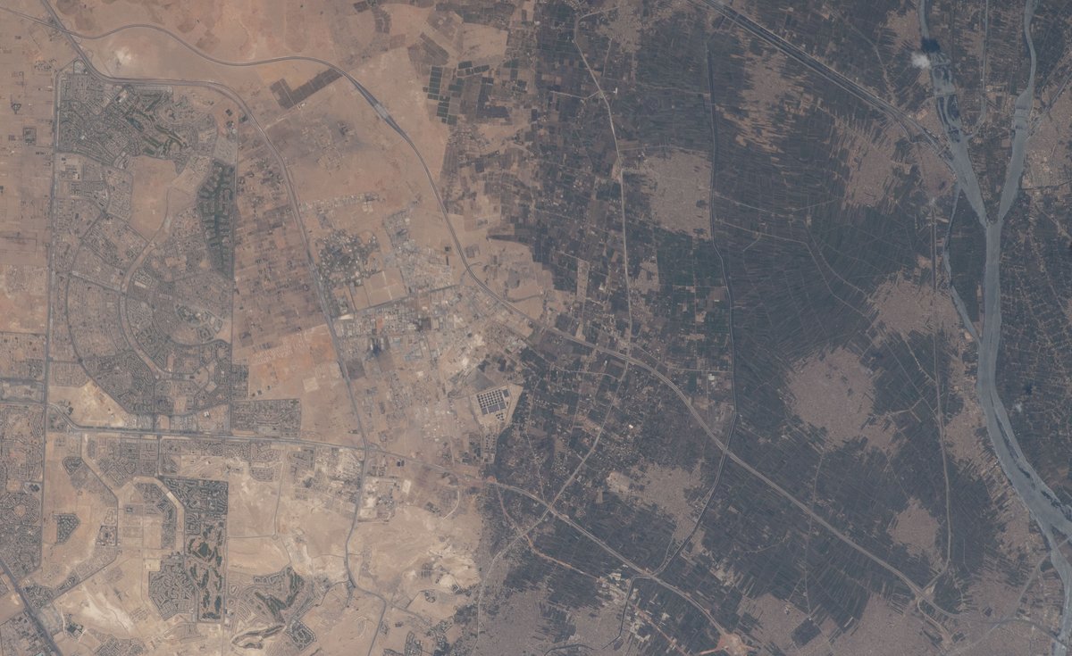 Aerial view of Greater Cairo and Giza districts including Sheikh Zayed City and Nile Delta towns west of the Nile River showcasing urban areas and agricultural lands
