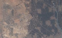 Aerial view of Greater Cairo and Giza districts including Sheikh Zayed City and Nile Delta towns west of the Nile River showcasing urban areas and agricultural lands