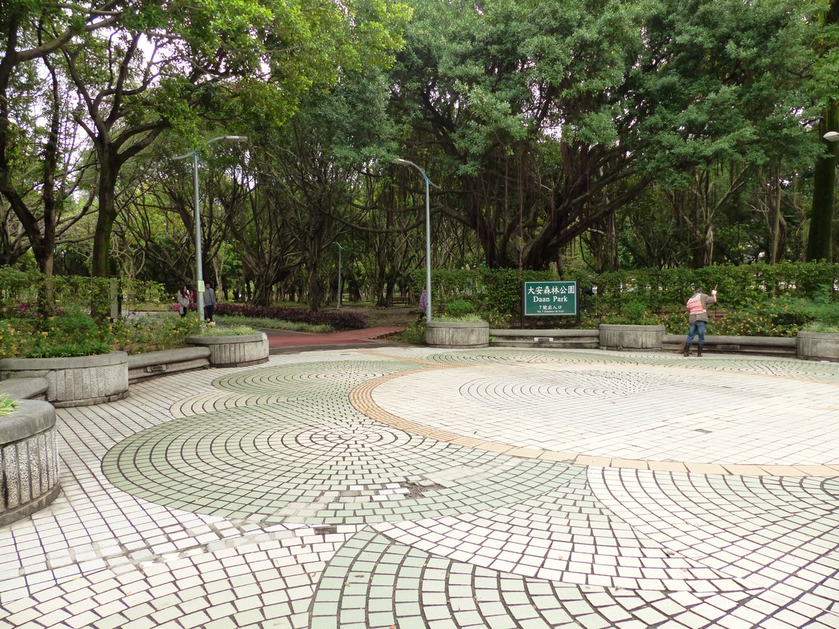 Daan Park Exit 7 south entrance with trees and modern buildings in Taipei