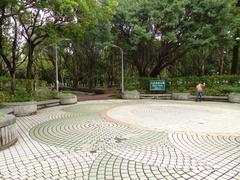 Daan Park Exit 7 south entrance with trees and modern buildings in Taipei