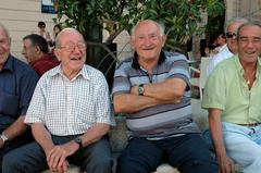 Old men sitting and conversing on Piazza Vittorio Veneto in Matera, Italy