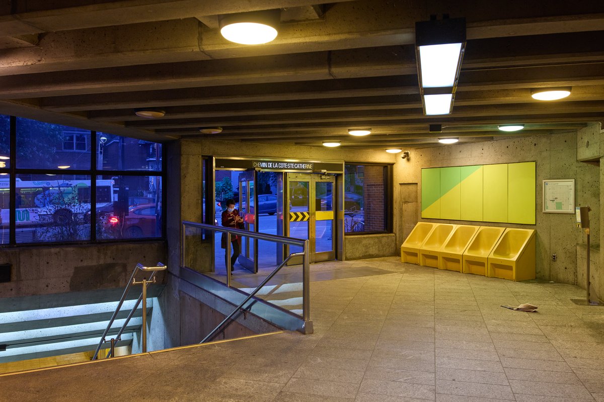 Interior view of Chemin de la Côte-Ste-Catherine metro station entrance with turnstiles and signage