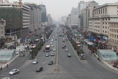 View from Xi'an Bell Tower overlooking ancient city rooftops and distant modern buildings