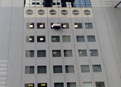Window cleaning at Umeda Sky Building with worker using safety ropes