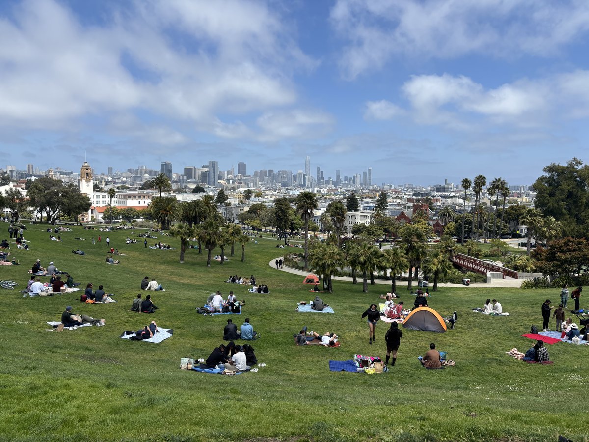 Dolores Park vibrant green space with people enjoying a sunny early afternoon in May 2025