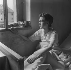 Emaciated woman looking from her bed through a window in Bergen-Belsen concentration camp, 1945
