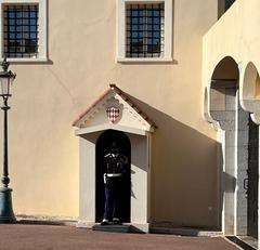 Prince's Palace of Monaco palace guard in traditional uniform standing at entrance in November 2021