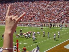 University of Texas football fan showing the hook'em horns hand sign
