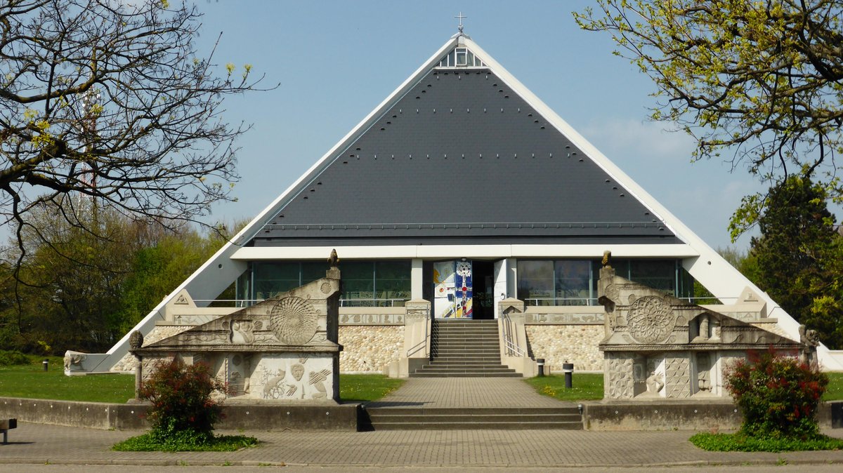 Autobahn church at Baden-Baden with modern cylindrical concrete architecture surrounded by trees