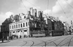 Destroyed tenement building on the corner of Miodowa Street and Krakowskie Przedmieście with a visible tram