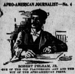 African American journalist Robert Pelham sitting at his desk