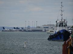 Tugboat Ocean Gulf in foreground with Billy Bishop Airport in background