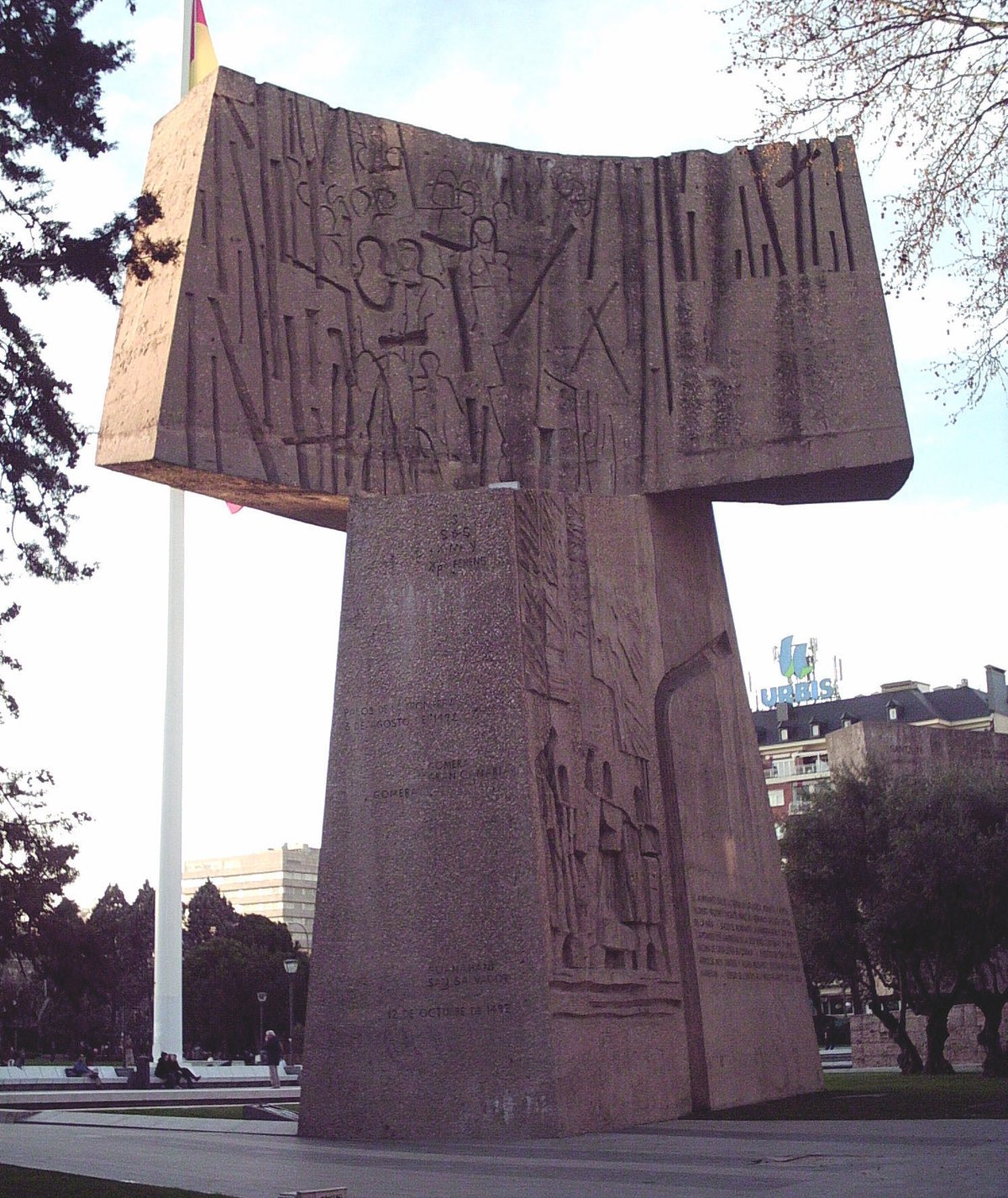 East side view of The Discovery sculpture, part of the Monument to the Discovery of America in Madrid, featuring detailed concrete figures