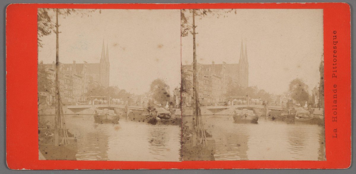 View of Singel 446-472 with R.K. kerk De Krijtberg church near the bridge between Koningsplein and Heiligeweg in Amsterdam