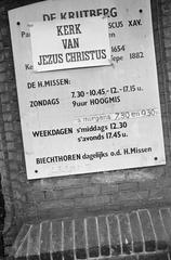 Black and white photo of posters on all churches in Amsterdam at De Krijtberg on Singel canal