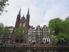 Exterior view of De Krijtberg church along Singel canal in Amsterdam