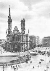 Historical black and white photo of Saviour Square in Warsaw before 1950 showing tall buildings and streetcars