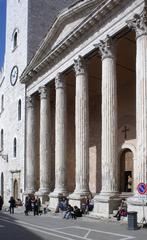 Black and white image of Assisi Piazza del Comune with historic buildings and clock tower