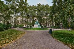 Elias Lönnrot Memorial statue in Helsinki with trees and sky