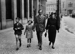 Family photograph of Petr Ginz with his sister Eva, father Ota, and mother Marie in Prague at Square of the Republic with U Hybernů House in background