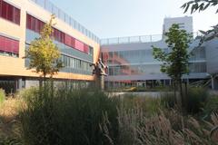 Masaryk University Campus building with blue sky and green lawn