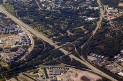 Aerial view of Malmi cemetery in Helsinki, Finland with dense green trees and organized burial plots