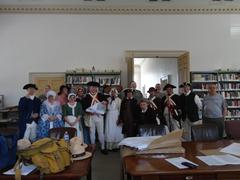 Historical reenactors dressed in 18th century colonial attire celebrating July 8, 1776