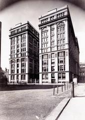 Ten-story office building with parking lot in front