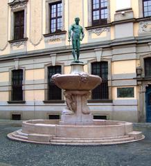 Fencer posing behind Wroclaw University building