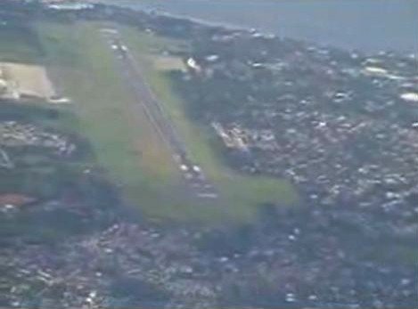 Davao International Airport runway with aircraft and control tower in view