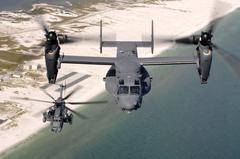 CV-22 Osprey and MH-53 Pave Low helicopters flying over coastline near Hurlburt Field Florida