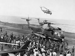 Evacuees from DAO Compound disembarking onto USS Midway aircraft carrier during Operation Frequent Wind 1975