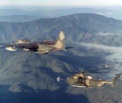 US Air Force Lockheed HC-130P Hercules refueling Sikorsky HH-53B Super Jolly Green Giant helicopter over North Vietnam