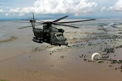 MH-53M Pave Low IV helicopter refueling mid-air over flooded Central Mozambique during Operation Atlas Response