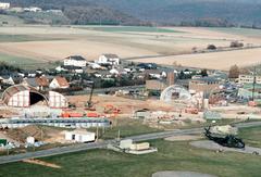 Aircraft hangars under construction near flight line at Sembach Air Base with a U.S. Air Force Sikorsky CH-53C helicopter parked, Germany 1983