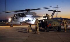 Airmen as movie extras with MH-53 helicopter portraying Decepticon Blackout on Transformers set at Holloman Air Force Base