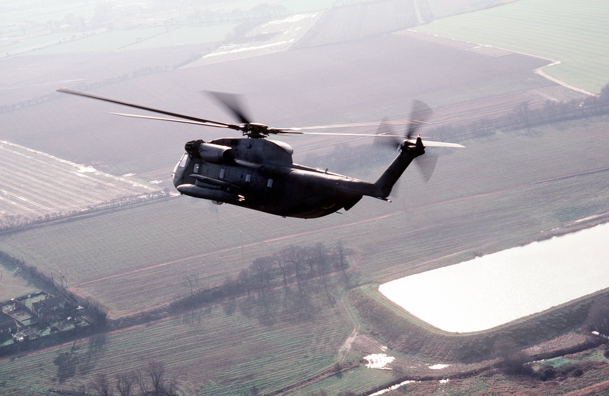 Air-to-air left rear view of an HH-53 Super Jolly helicopter in flight