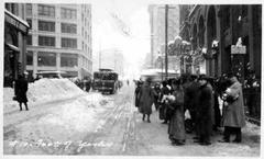 Commuters waiting for trolley at Yesler Way in snowy Seattle 1916