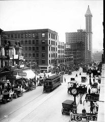 Historic black and white photograph looking south on 2nd Avenue from Marion Street in Seattle circa 1915 showing the L.C. Smith Building on the right amid streetcars and early automobiles