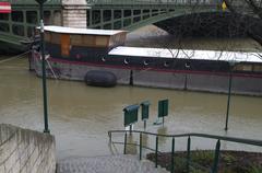 The Seine River at Pont de Sully bridge under a cloudy sky