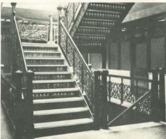 Interior view of the Monadnock Building stairwell with wrought iron railings and wooden handrail
