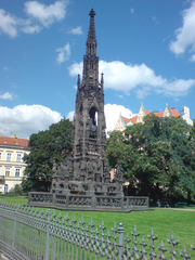 Monument in Prague featuring intricate sculptures and historic architecture