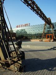Entrance to the Originality Square of 798 Art Zone with industrial-style architecture and people walking